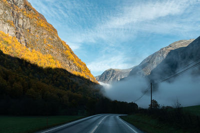 Road amidst mountains against sky