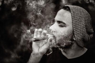 Close-up of man smoking cigar