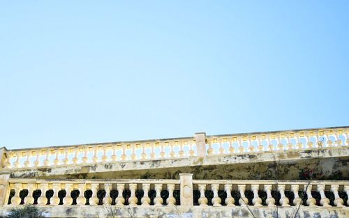 Low angle view of historical building against blue sky