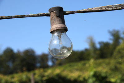 Low angle view of light bulb against sky