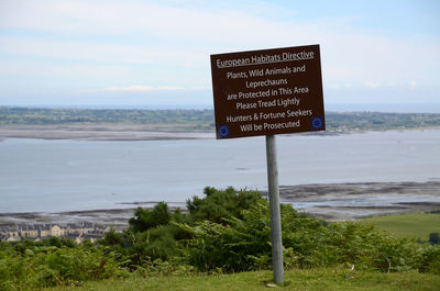 Information sign on grassy field