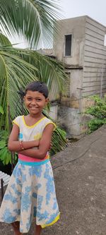Portrait of smiling girl standing outdoors