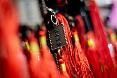 Close-up of red bell hanging at temple