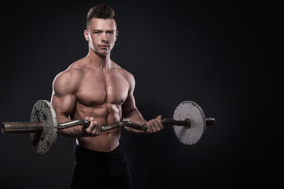 Portrait of young man exercising in gym