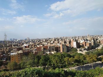 High angle view of trees and buildings against sky