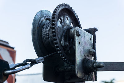 Low angle view of machine part against clear sky