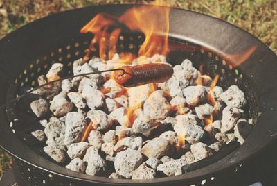 High angle view of sausage being roasted over fire