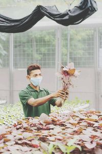 Portrait of boy wearing flowers