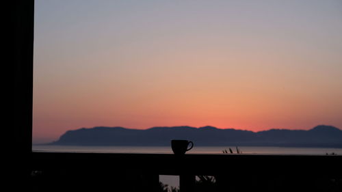 Scenic view of silhouette mountains against sky during sunset