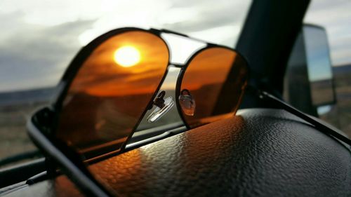 Sun seen through sunglasses in car