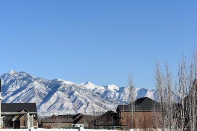 Snowcapped mountains against clear blue sky