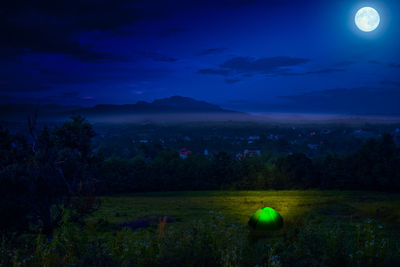 Scenic view of landscape against sky at night