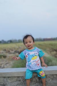 Portrait of cute baby girl on land