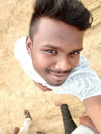 Portrait of smiling man standing outdoors