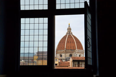 Building against sky seen through window