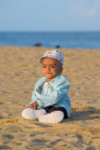 Portrait of boy sitting at beach