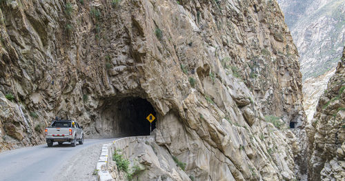 Car on road by rocky mountains