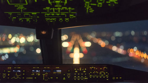 Low angle view of illuminated lighting equipment on display at night
