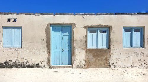 Exterior of old building against clear blue sky