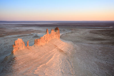 Scenic view of beach against sky during sunset