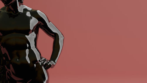 Low angle view of statue against pink background