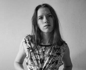 Portrait of beautiful young woman against white background