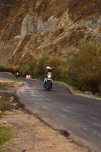 Man riding motorcycle on road