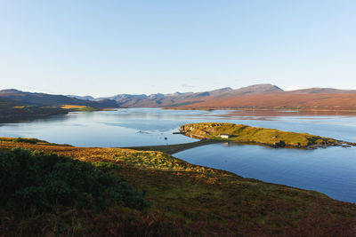 Scenic view of lake against clear sky with island in scotland