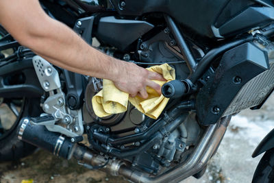 Biker cleaning motorcycle by microfiber cloth. motorcycle retailing.