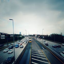 Traffic on highway in city against sky