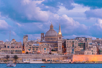 Buildings against cloudy sky