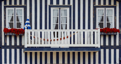 Typical colourful houses with blue and white stripes in costa nova - aveiro against sky