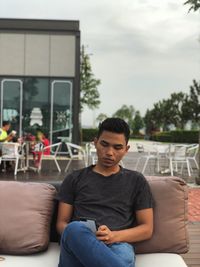 Young man sitting on chair