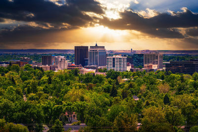 Buildings in city against sky during sunset