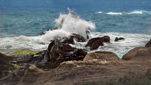 Waves breaking on rocks at shore