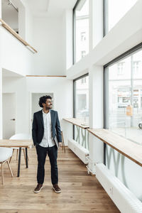 Full length of young man standing on table
