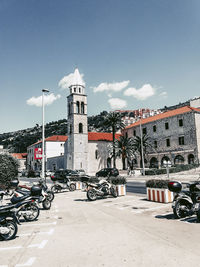 Street amidst buildings in city against sky