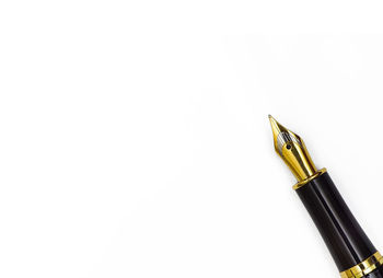 Close-up of pen over white background