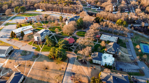 High angle view of buildings and trees in city