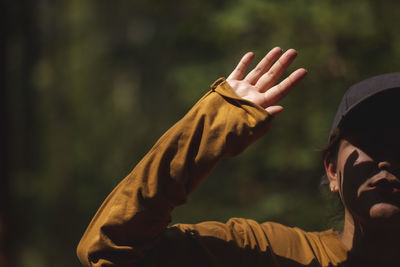 Close-up of woman gesturing outdoors