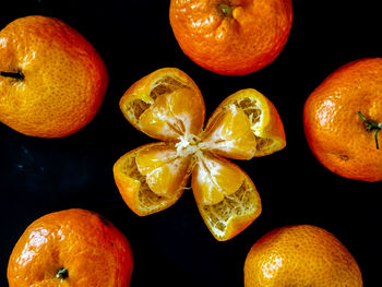 Close-up of orange fruits against black background