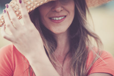 Smiling young woman wearing hat