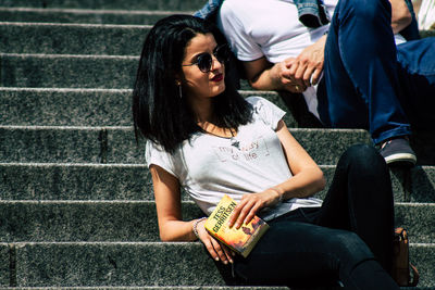 Young woman sitting on book