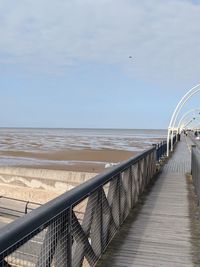 Pier over sea against sky