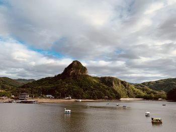 Scenic view of sea and mountains against sky