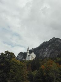 Historic building by mountain against sky