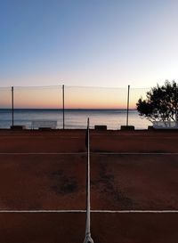 Scenic view of sea against clear sky at sunset