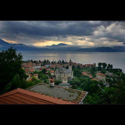 View of cityscape against cloudy sky