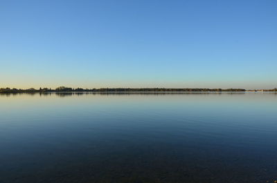 Scenic view of sea against clear blue sky