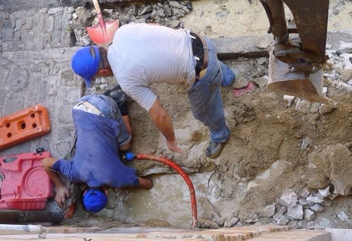 HIGH ANGLE VIEW OF MEN WORKING WITH WATER